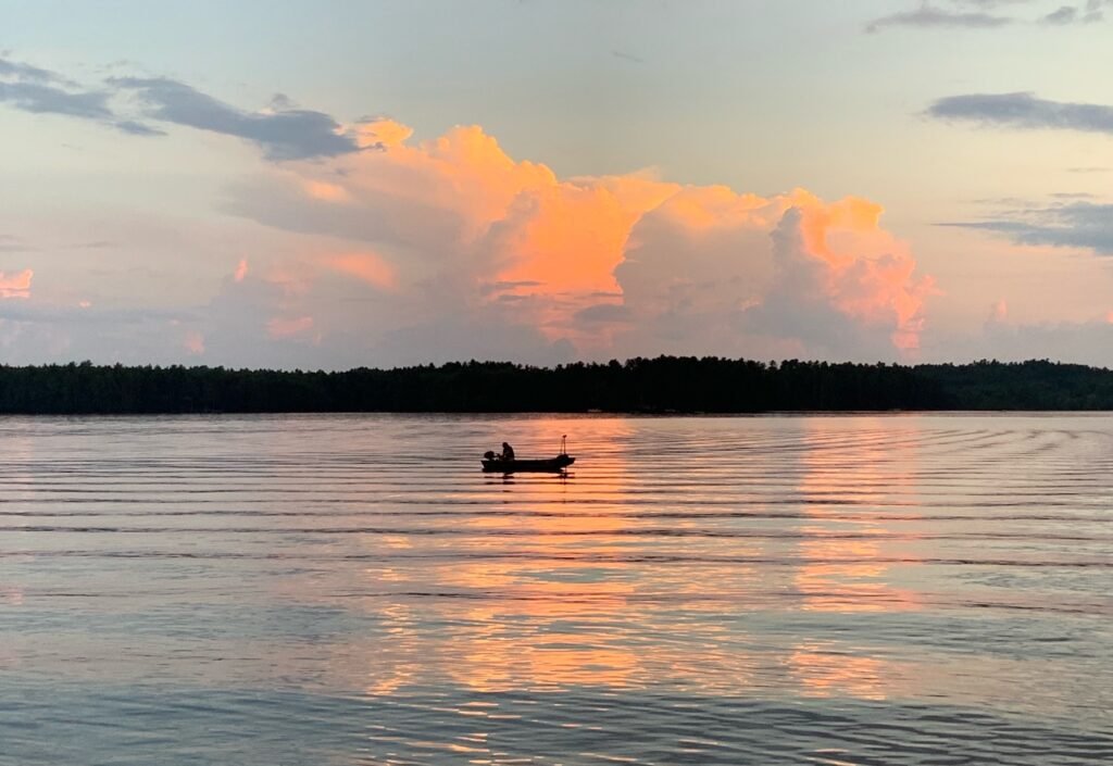 Lone boater on Thomas Pond at sunset